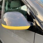 Wing mirror of grey VW campervan